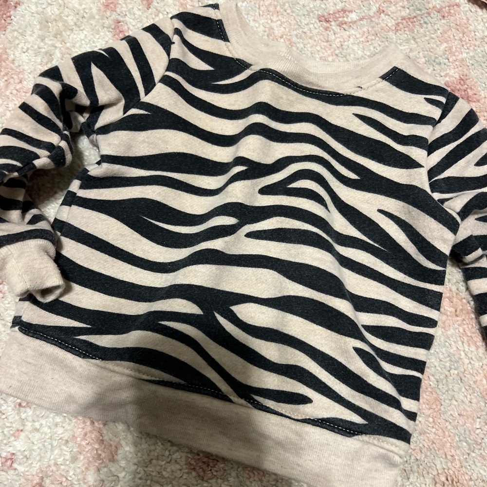 Garanimals 6-9 months. Long sleeve zebra sweater. Used condition.